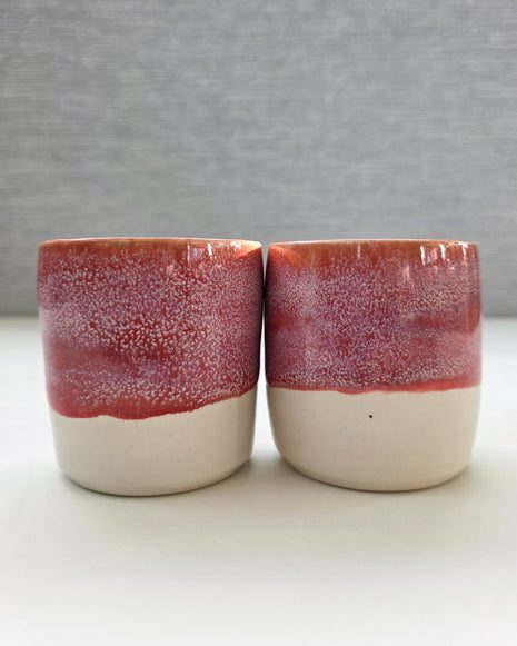 set of two handmade ceramic lungo cups with speckled berry pink glaze and white base