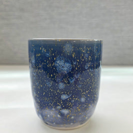 handmade ceramic cup with periwinkle glaze and small yellow speckled details