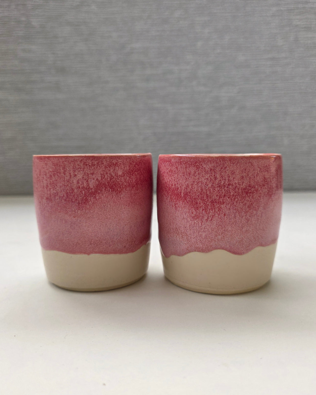 set of two handmade ceramic lungo cups with a rose glaze and warm white base