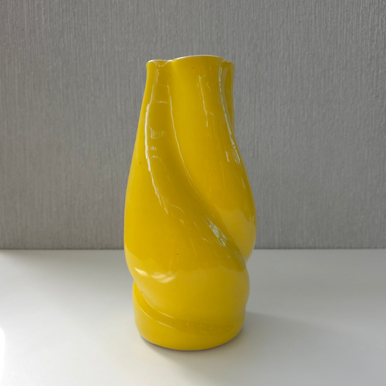 a bright yellow sculptural ceramic vase