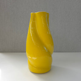 a bright yellow sculptural ceramic vase