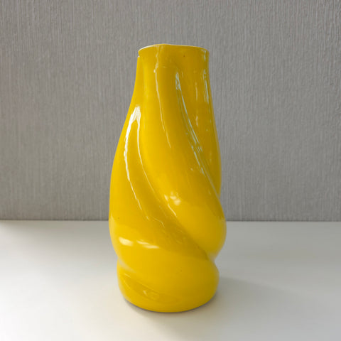 a bright yellow sculptural ceramic vase 