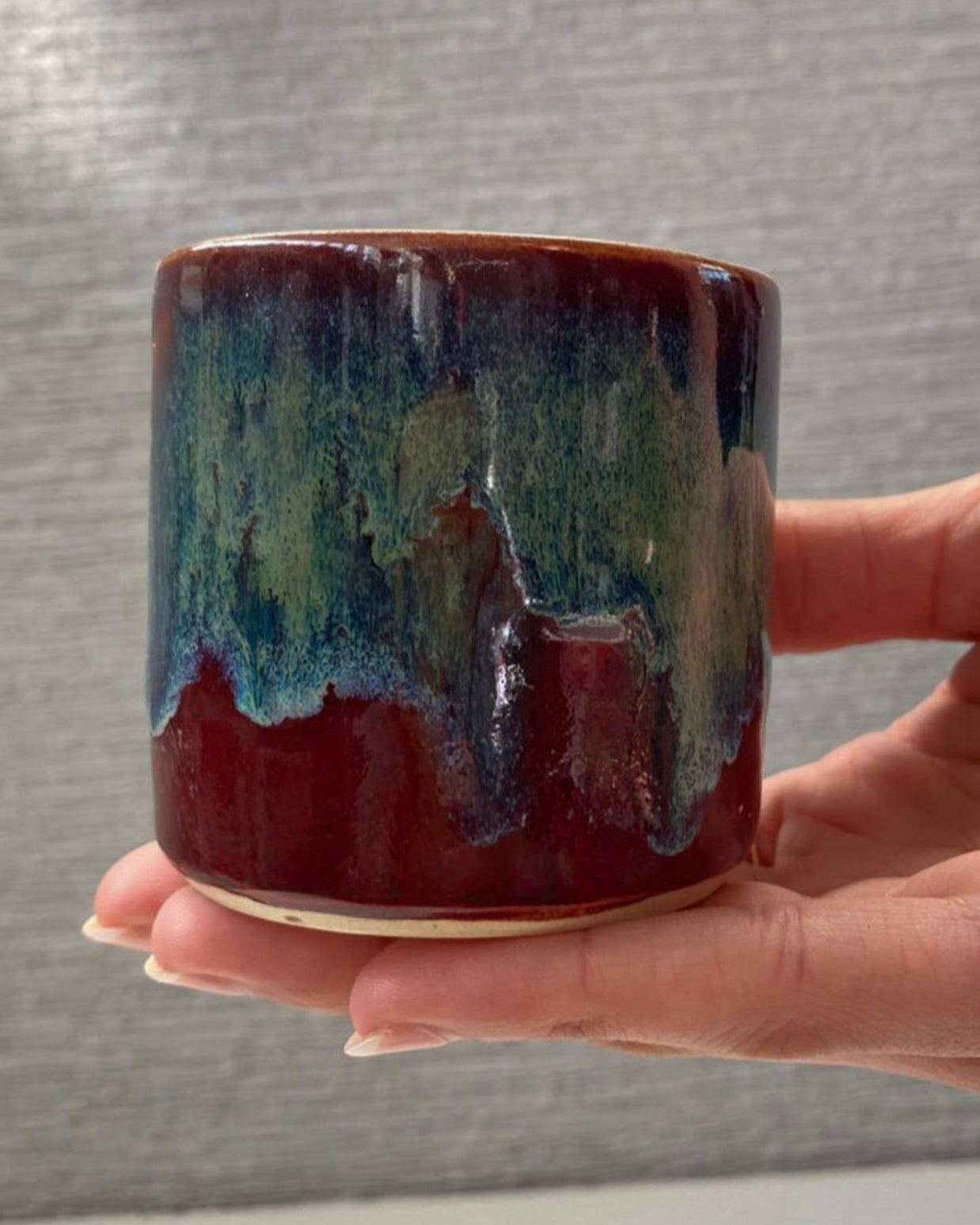handmade ceramic lungo cup with deep maroon glaze and teal wash detail