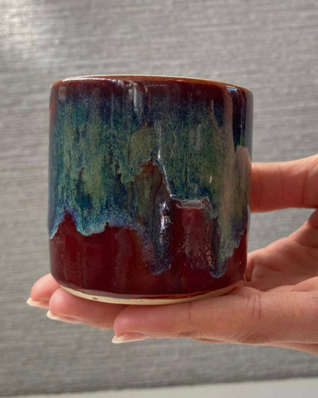 handmade ceramic lungo cup with deep maroon glaze and teal wash detail