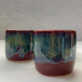 set of two handmade ceramic lungo cups with deep maroon glaze and teal wash detail