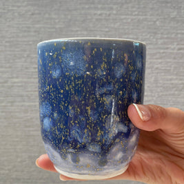 handmade ceramic cup with periwinkle glaze and small yellow speckled details