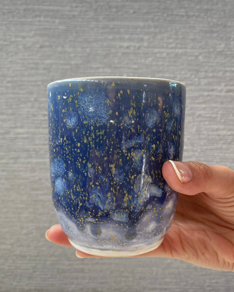 handmade ceramic cup with periwinkle glaze and small yellow speckled details