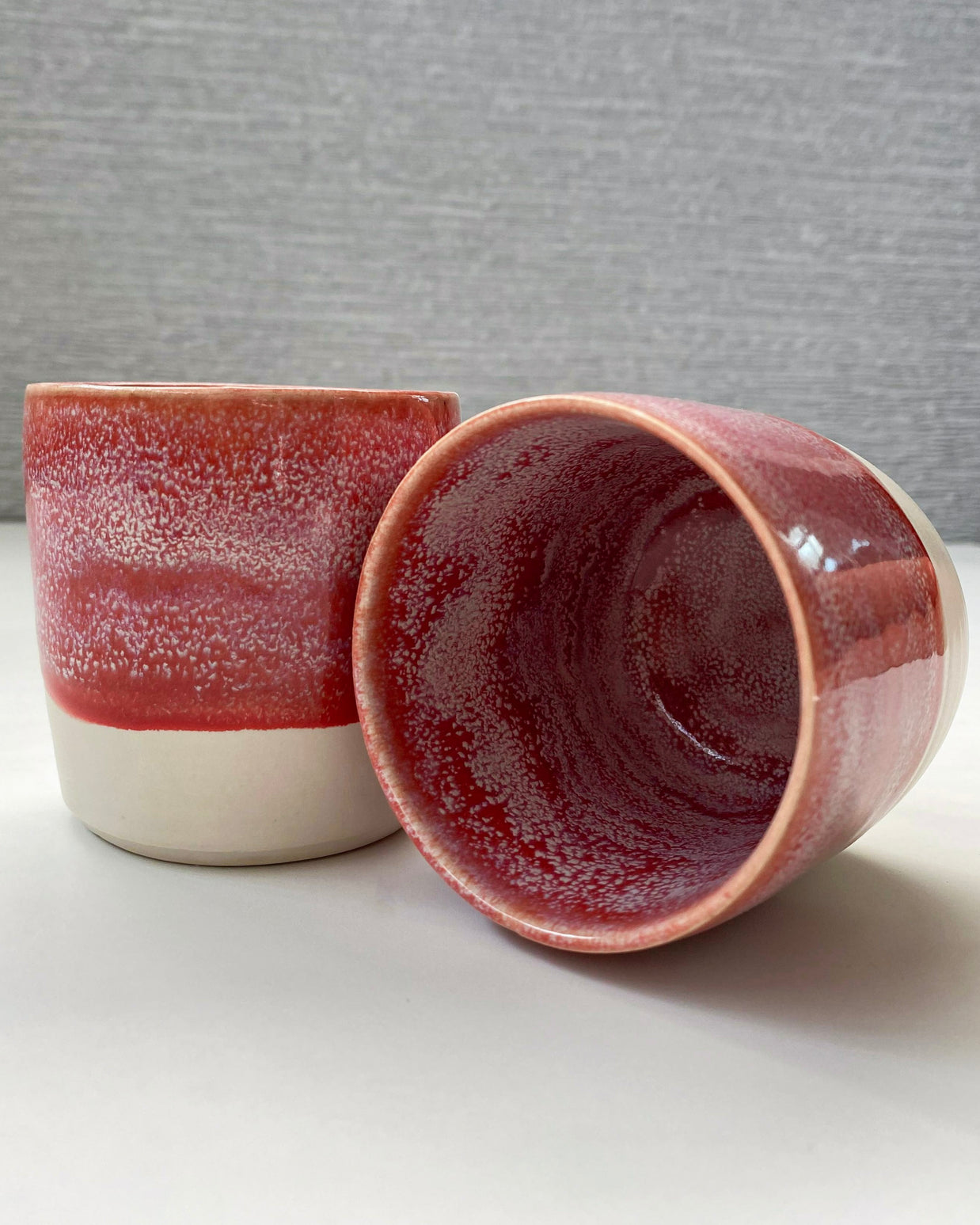 set of two handmade ceramic lungo cups with speckled berry interior