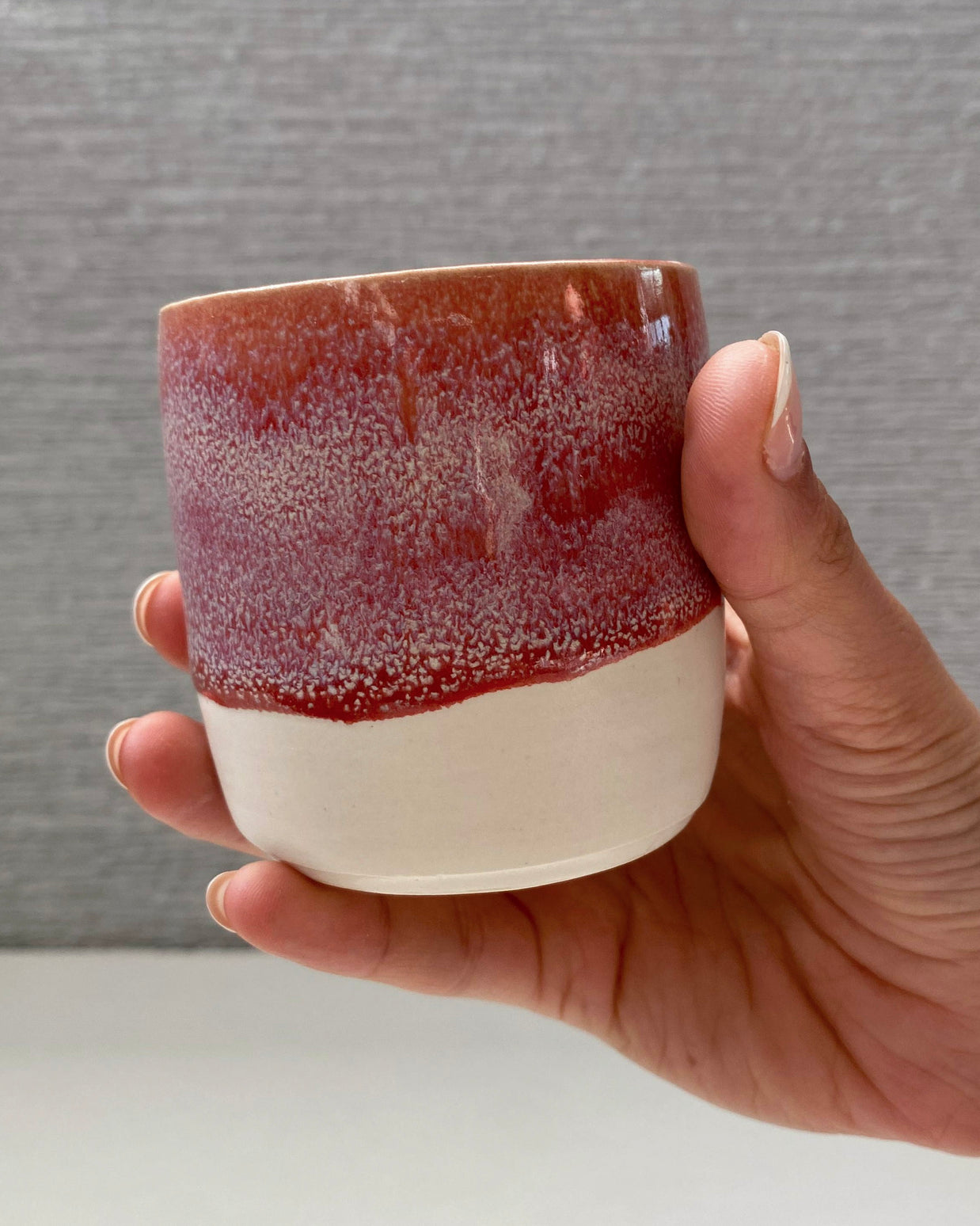 handmade ceramic lungo cup with speckled berry pink glaze and white base
