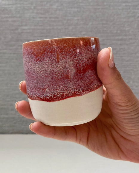 handmade ceramic lungo cup with speckled berry pink glaze and white base