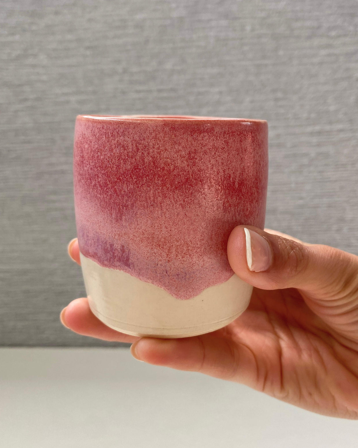 handmade ceramic lungo cup with a rose glaze and warm white base